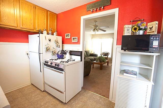 kitchen complete with double sink, garbage disposal, fridge,