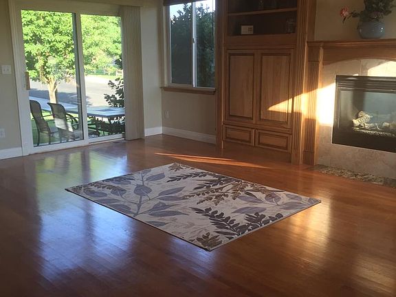 Living/dining room with gas fireplace and vaulted ceiling.