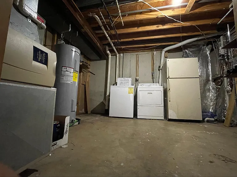 Utility and appliance room in basement.