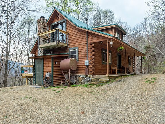 East side of log cabin with upstairs bedroom balcony!