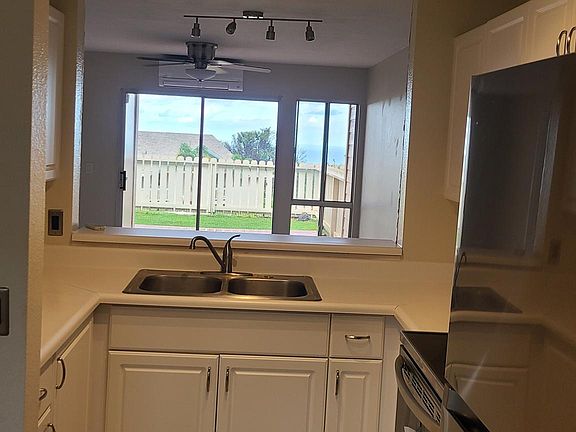 Open view from kitchen into living/dining/patio area