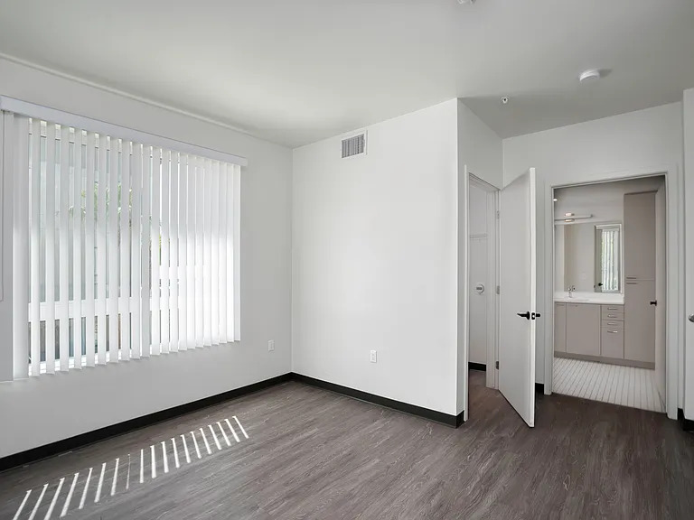 Bedroom A with private bathroom access and abundant natural light