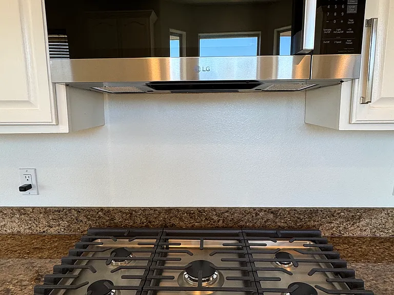Brand New LG 5 Gas Stove burners and brand new LG Microwave with fan exhaust.