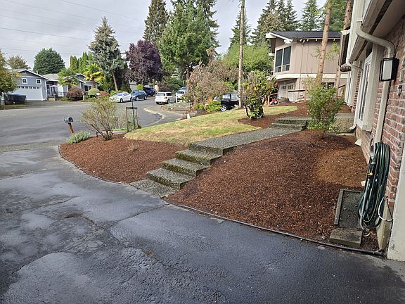 View from driveway looking across front yard and up cul-de-sac.