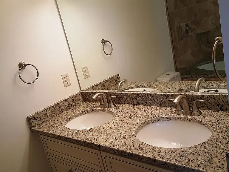 Master bath with double sink and granite countertops