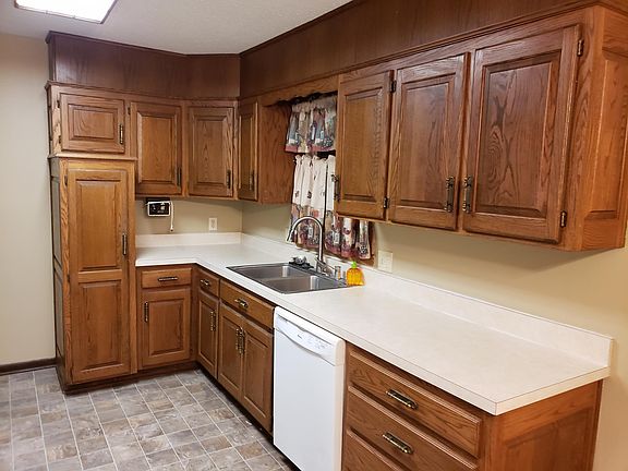 Large eat in kitchen with nice hard wood cabinets, built in microwave, gas range, refrigerator, dishwasher, garbage disposer and more.