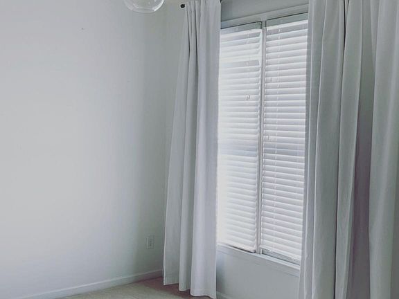 Third floor secondary bedroom has amazing lighting and giant windows.