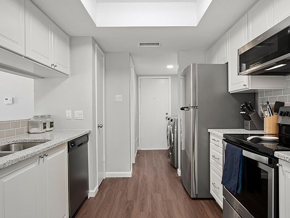 Brand new Ikea kitchen features soft close doors, quartz countertops, and stainless steel appliances.