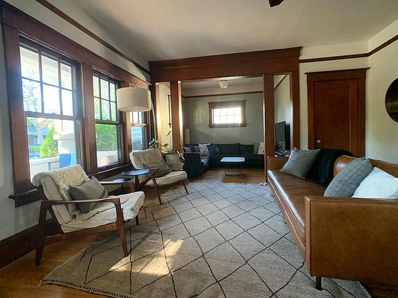 Large living room with adjacent room. Coat closet located inside that door.