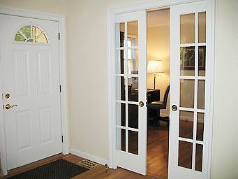 Double glass pocket doors lead to home office or bedroom