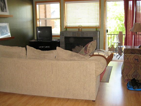 Living area with gas fireplace with sliding glass doors to small deck.