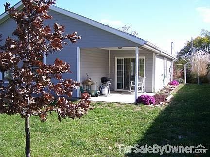 Back yard to patio off the dining room
						:
						Flowers bloom yearly and trees are doing well.