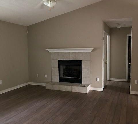 Living room view with electric logs in fireplace