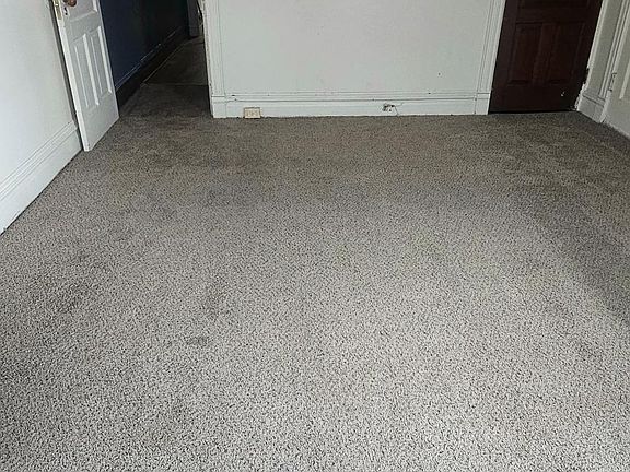 Main floor carpeted bedroom #2 with closet