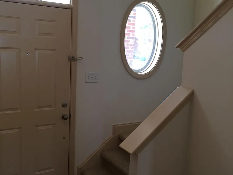 Front entryway and stairs to second floor bedrooms, two full baths and laundry area. Front storage closet is under the stairs.