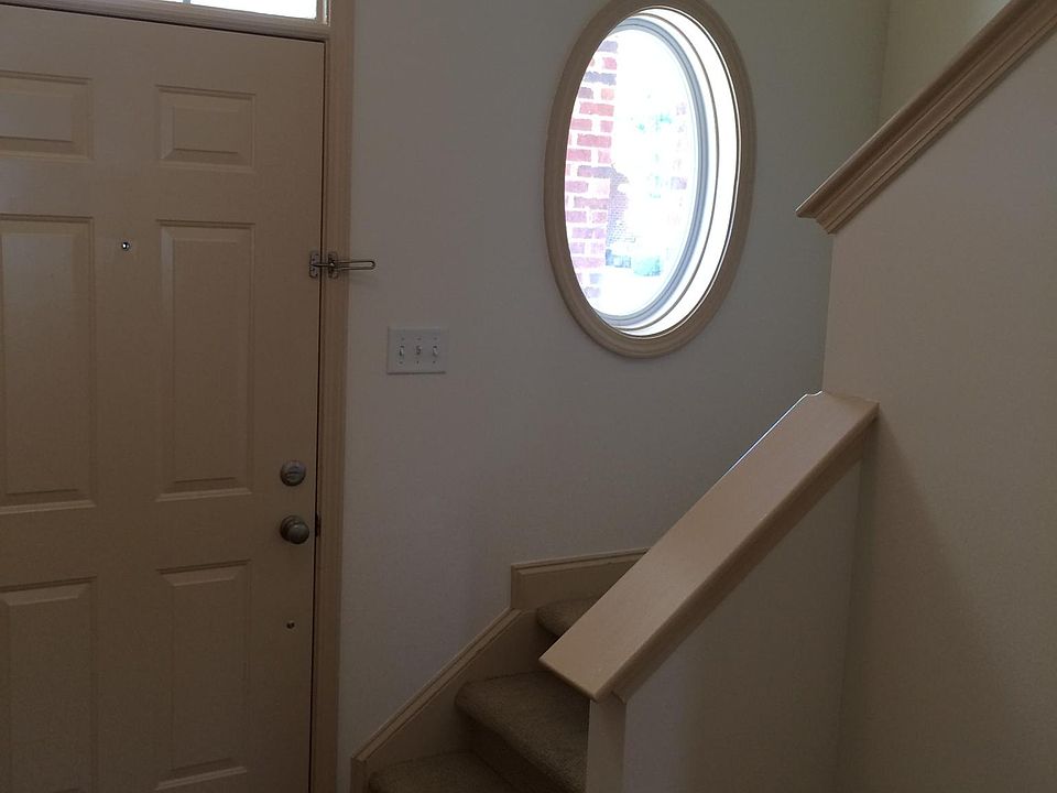 Front entryway and stairs to second floor bedrooms, two full baths and laundry area. Front storage closet is under the stairs.