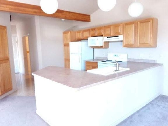 from dining to kitchen towards bath on right and front door