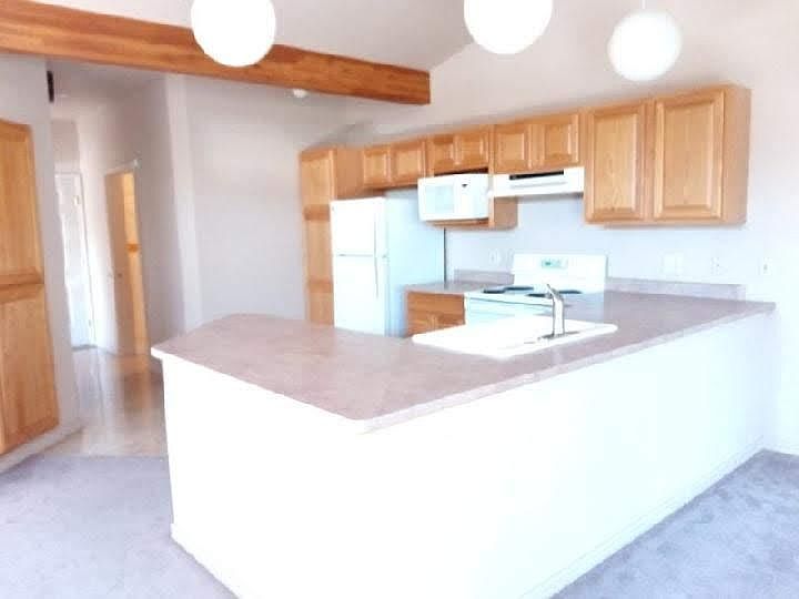 from dining to kitchen towards bath on right and front door