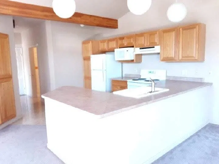 from dining to kitchen towards bath on right and front door