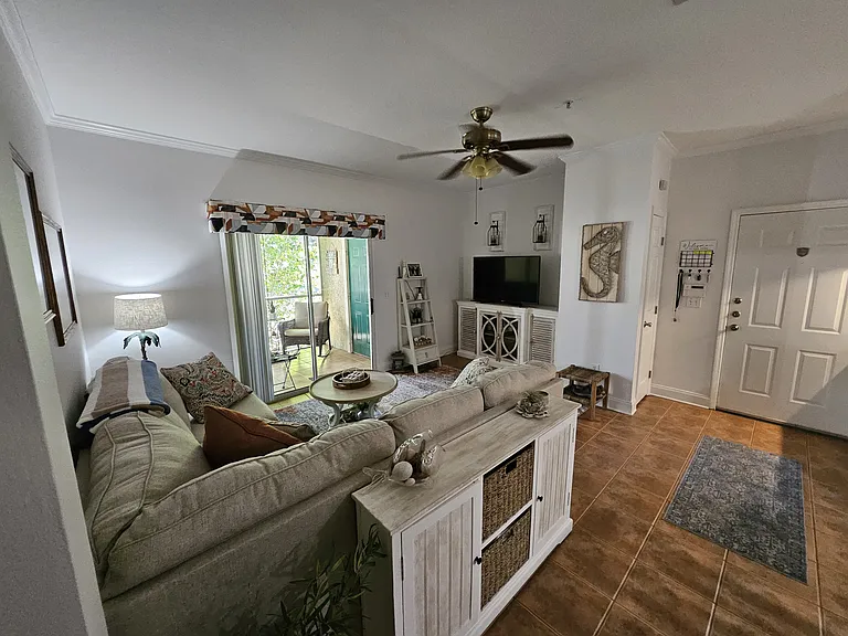 Living room with TV console and entrance with hall closet