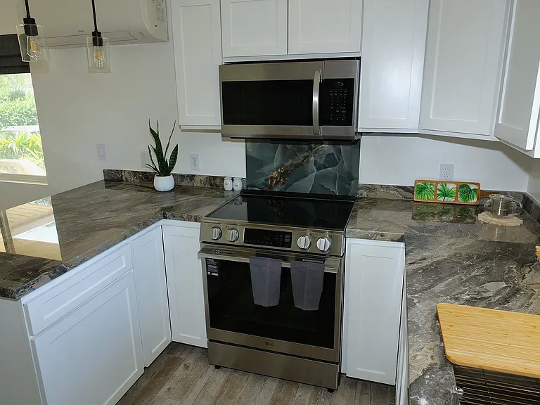 Induction stove with over stove microwave and vent