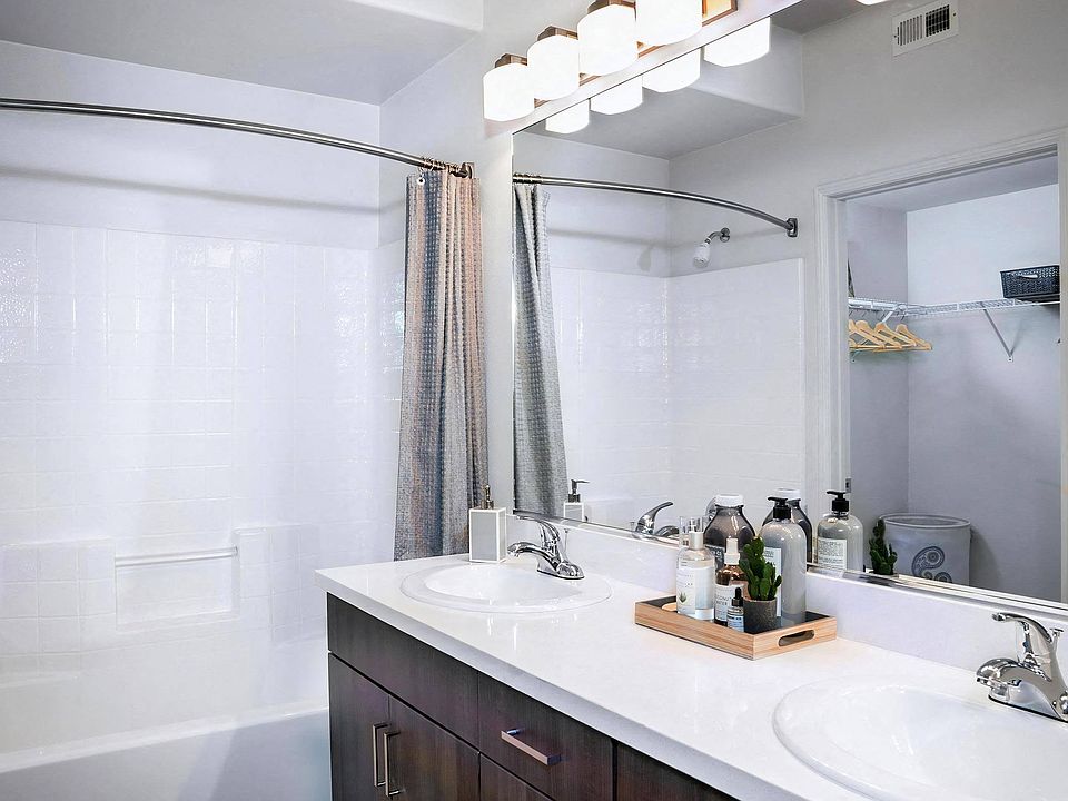 Double Vanity Bathroom with Ample Storage and Contemporary Lighting