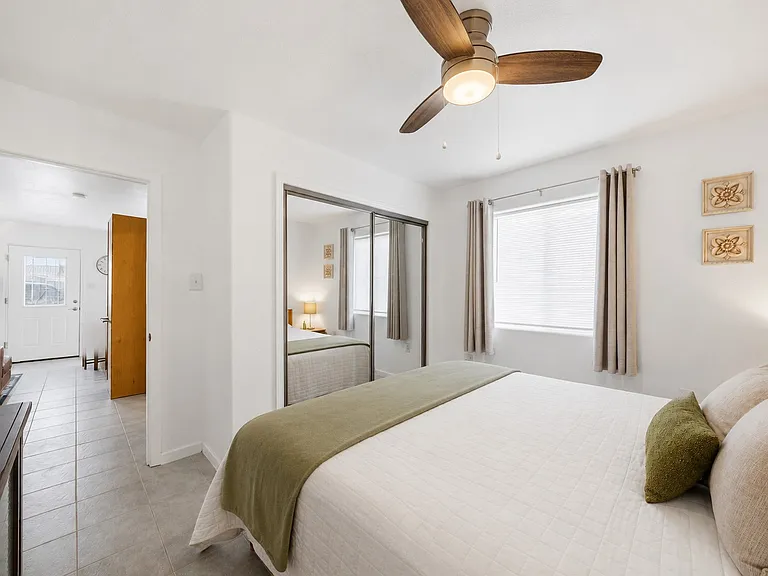 PRIMARY BEDROOM (King Size Bed) Closet Space, Ceiling Fan, Entertainment Stand and TV