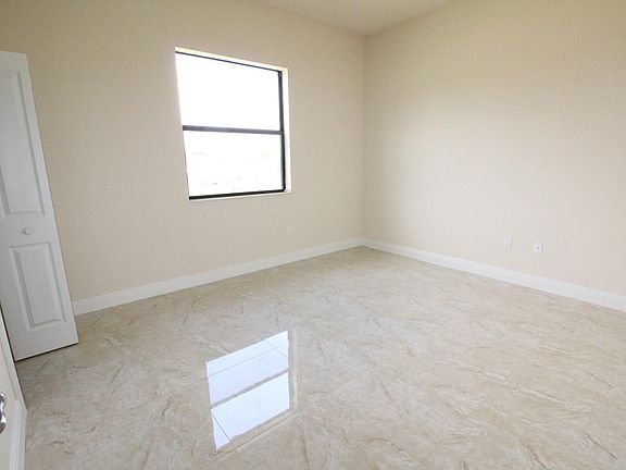 View of Bedroom with Window and entrance to walk-in closet