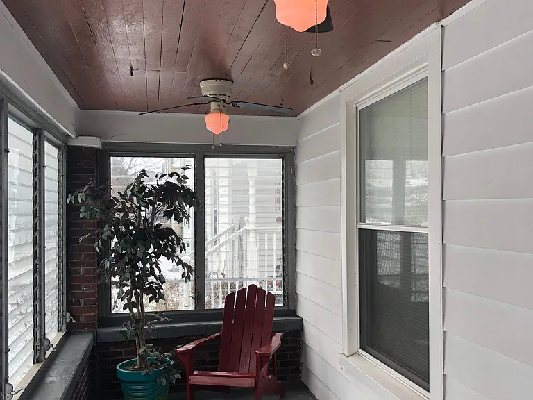 Enclosed front porch with three lighted ceiling fans