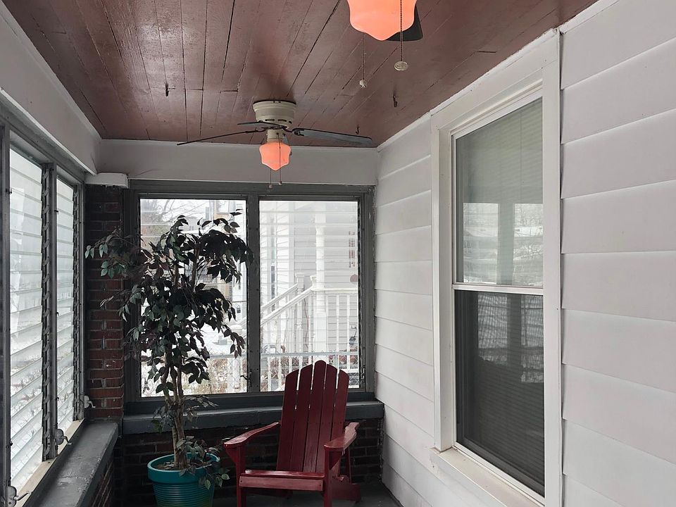 Enclosed front porch with three lighted ceiling fans