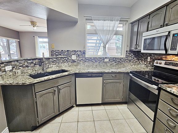 Custom Granite Kitchen, Glass Tile Backsplash, Stainless Steel Appliances, Black Composite Granite Dual Bowl Sink