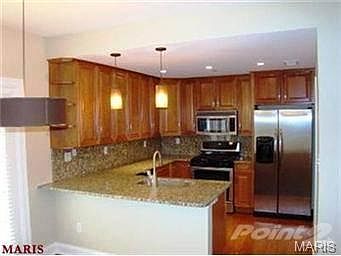 awesome kitchen with stack laundry in each unit!