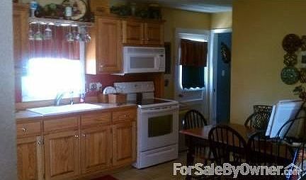 Kitchen
						:
						Plenty big for table with 6 chairs, back door walks out to patio.
