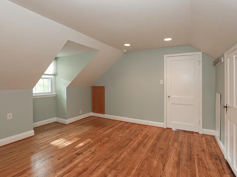 Upper bedroom with hardwood floors and dormer window.