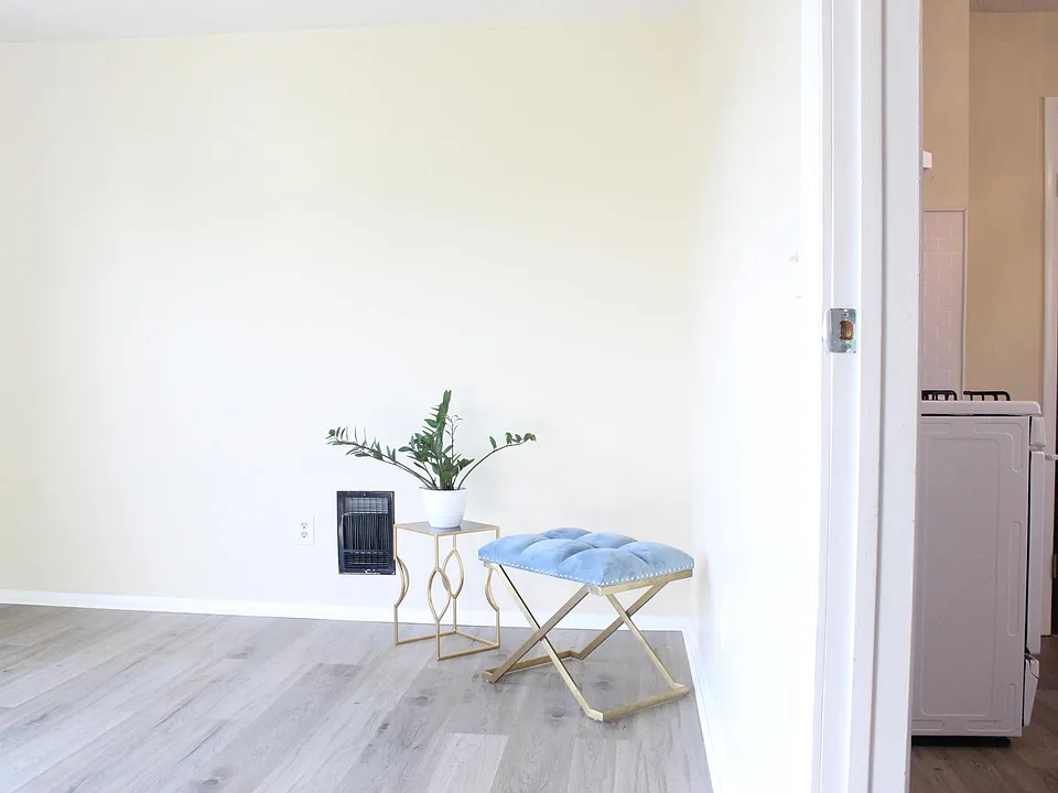The living room is adjacent to the kitchen.