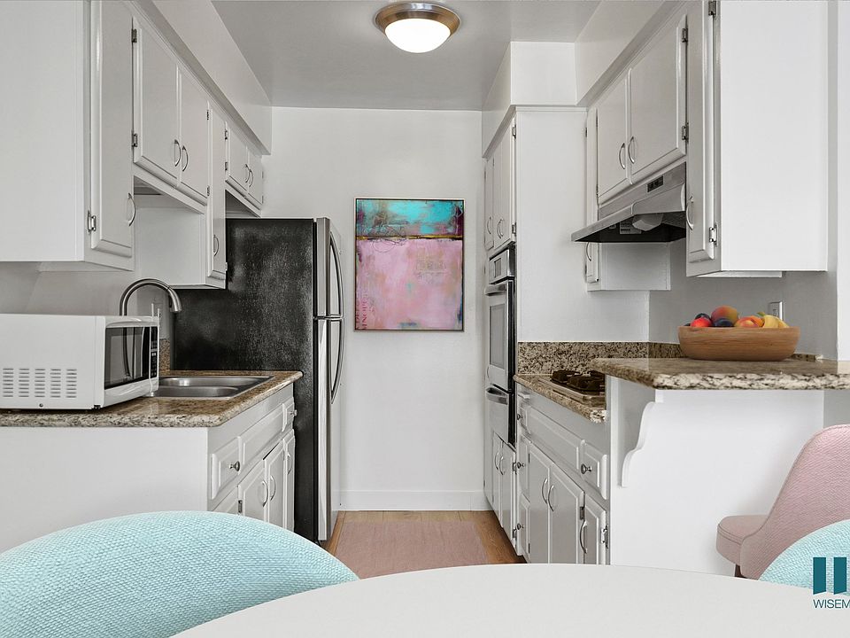 Kitchen with Stainless-Steel Refrigerator, Stovetop, and Oven