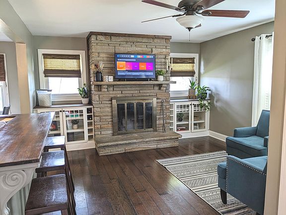Den area with wood burning fireplace