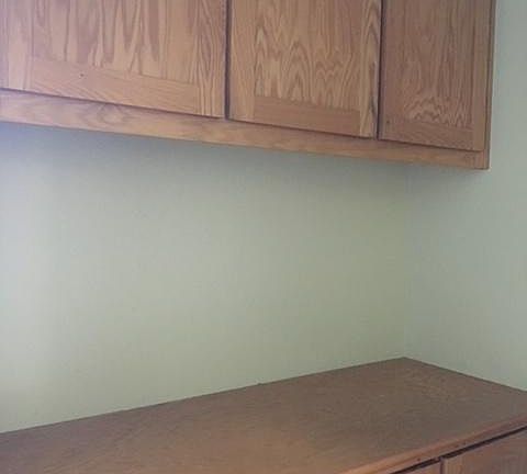 Hallway cabinets, in front of the laundry room.