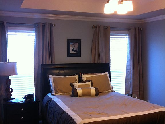 Fresh paint, carpet, and remote control ceiling fan in the master bedroom