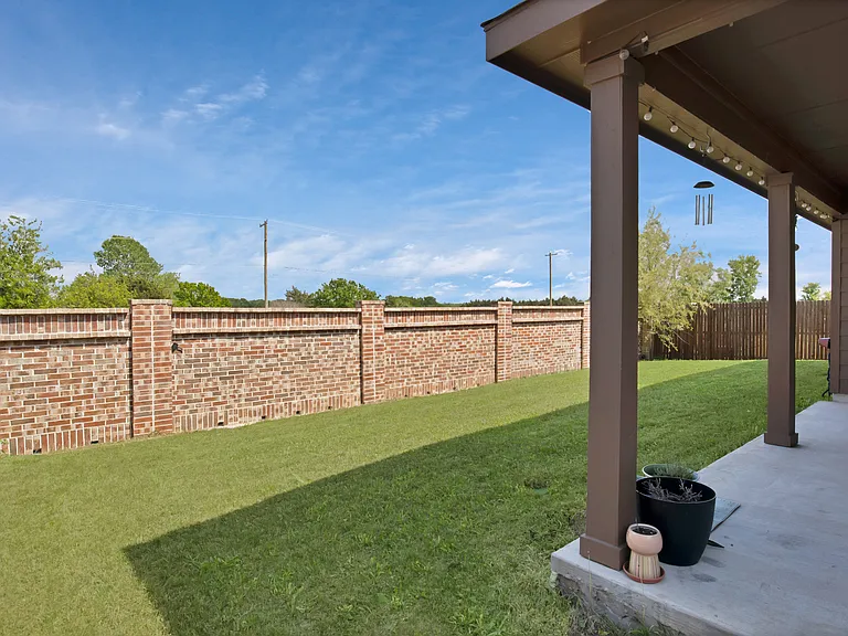 View of yard with a fenced backyard and a patio