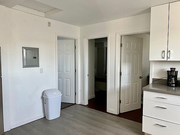 Kitchen area with bedroom 1, 2, and bathroom entrance