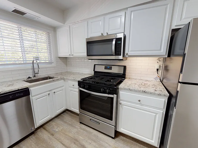 Reimagined kitchen with custom shaker style cabinetry and chrome pulls