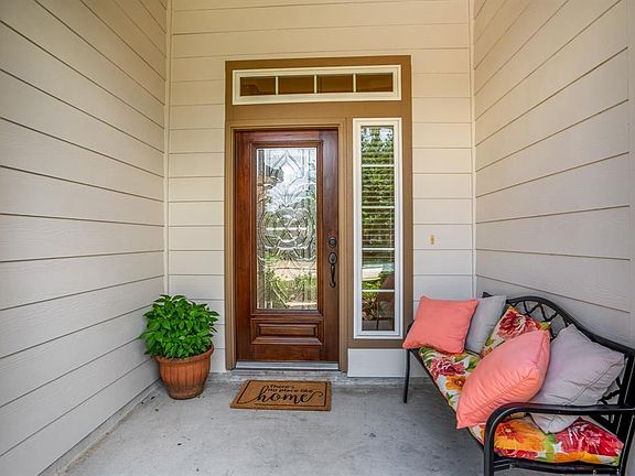 A covered porch is the perfect place to greet guests as you welcome them into your new home.