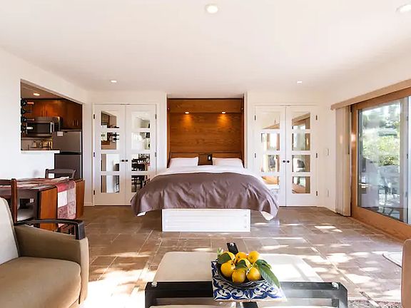 View of murphy bed with mirrored closet doors on either side of the bed.