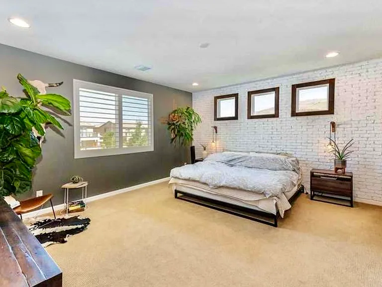 Large master bedroom with custom brick inlay accent wall