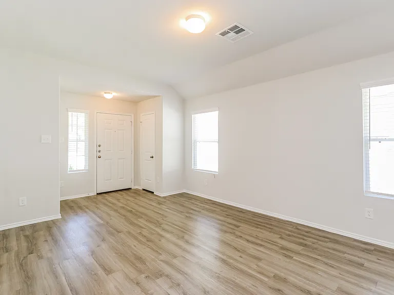 Inviting entryway with elegant wood flooring, abundant natural light, and modern lighting fixtures in a contemporary apartment. Inviting entryway with elegant wood flooring, abundant natural light, and modern lighting fixtures in a contemporary apartment.