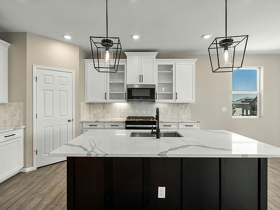 The Snowberry s designer decorated kitchen spills into the dining room allowing for an open feel.