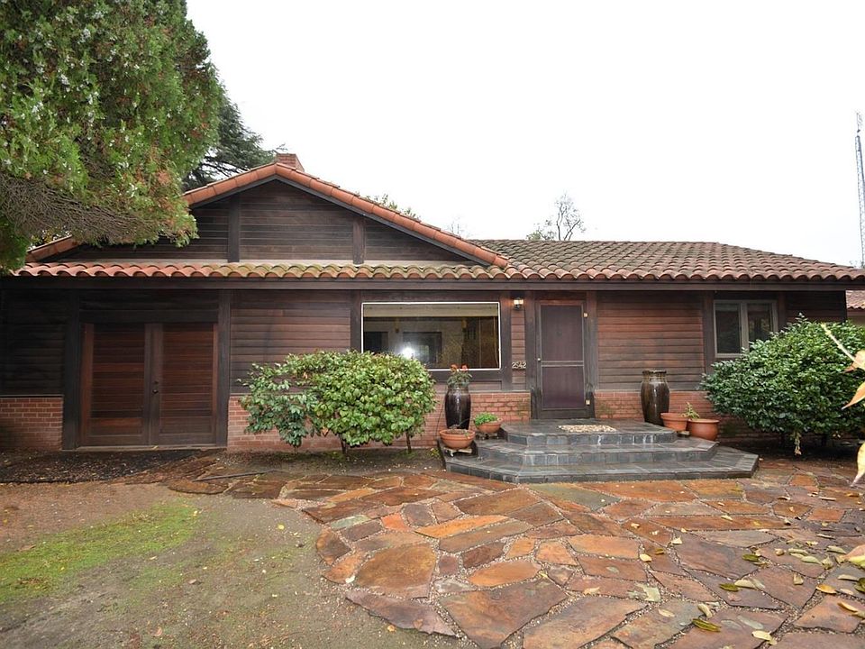 Ranchette living at itâ??s best yet minutes from hwy 99. Offering two homes on nearly one acre, this property offers privacy and a tranquil setting. The main home features 2 bedrooms, 1 bathroom, 1420 sf and custom features throughout. The guest house offers 1 bedroom, 1 bathroom, 1296 sf, open area on the first floor plus a beautiful loft featuring an Asian inspired theme with built in tatami mats and abundance of windows for natural lighting. This space would make an amazing studio or additional living area.  The marvelous Asian inspired backyard offers a wrap-around deck & connecting bridge to the guest house, lovely pond with waterfall, variety of fruit trees and custom stone work used for steps, bridge, bench and patio area.  This amazing property is waiting for a new owner to make it their own private getaway oasis.