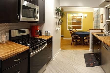View of kitchen and dining from back door entryway
