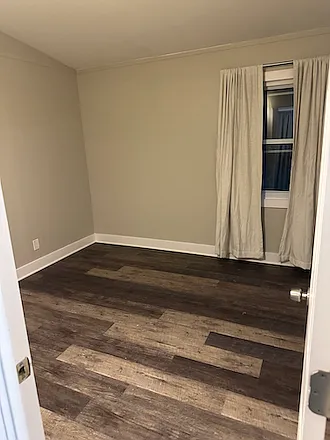 Bedroom 1 closest to the bathroom. features in-floor radiant heat with dedicated thermostat. There is also a portable floor AC unit.